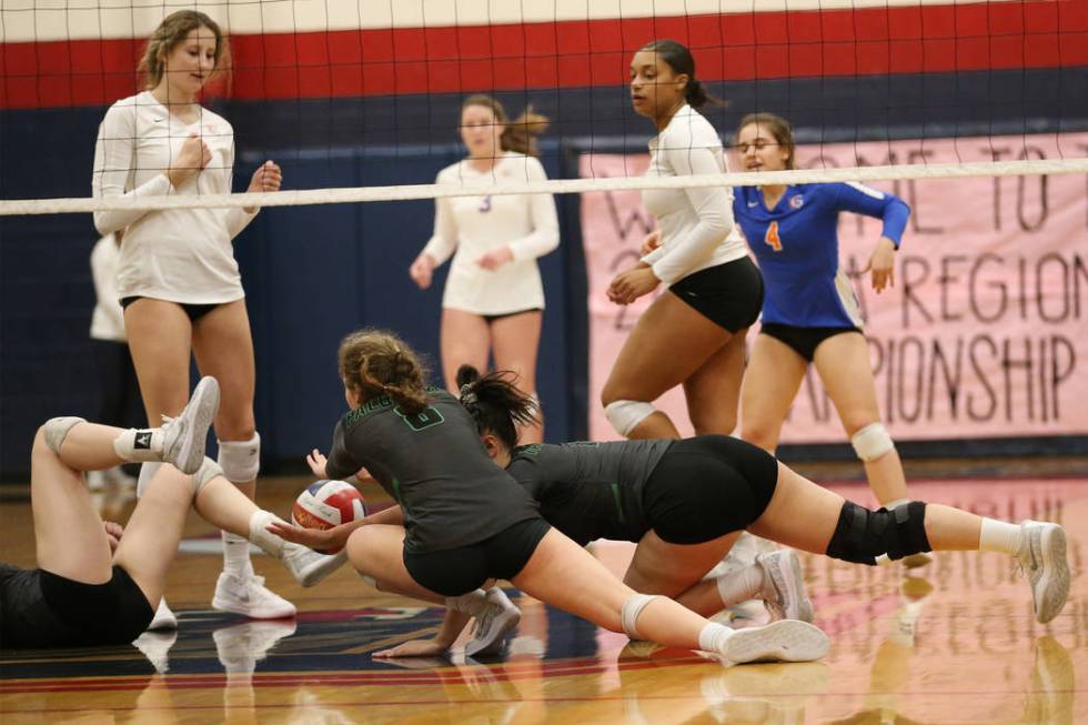 Palo Verde players dive as the ball drops for a point for Bishop Gorman during the third set ...