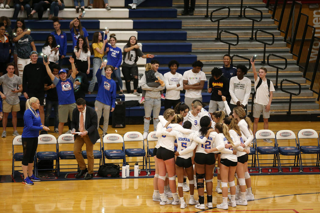 Bishop Gorman players huddle as they get ready for the third set against Palo Verde in the g ...