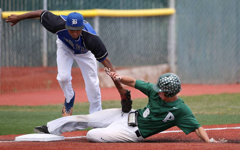 Palo Verde’s Tyler Kim slides safely under the tag of Basic’s Garrett Giles duri ...