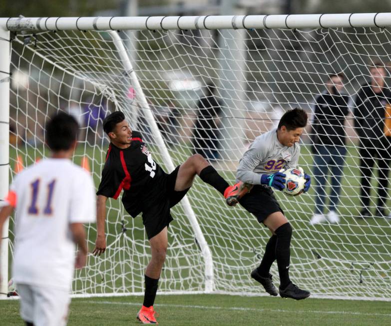 Durango’s Jason Sotelo (92) makes a save in front of Las Vegas’ Nathan Zamora (1 ...