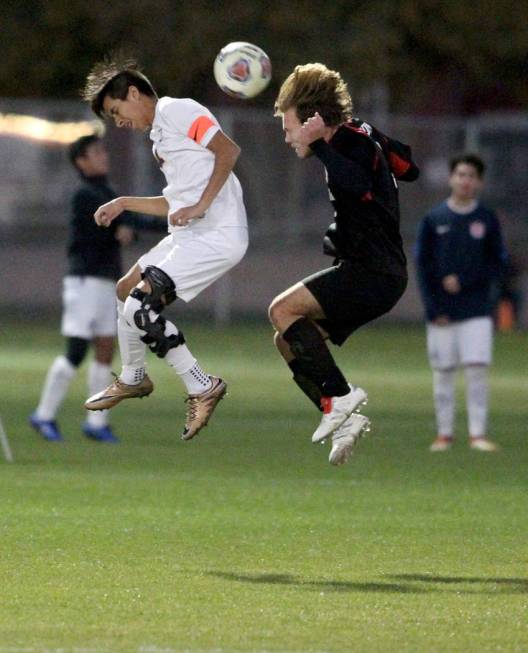 Durango’s Christopher Bramasco (11), left, and Las Vegas’ Drew Bowden (2) battle ...