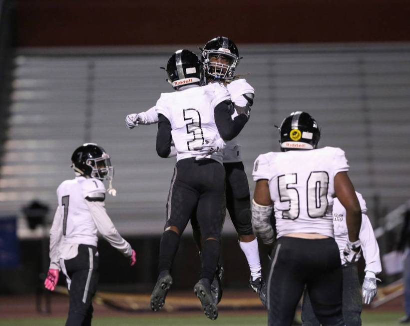 Desert Pines’ Jamel Brown (3) and Desert Pines’ Darius Stewart (5) celebrate aft ...