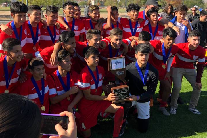 Western boys soccer players pose with the Class 3A state championship trophy after a 3-1 vic ...