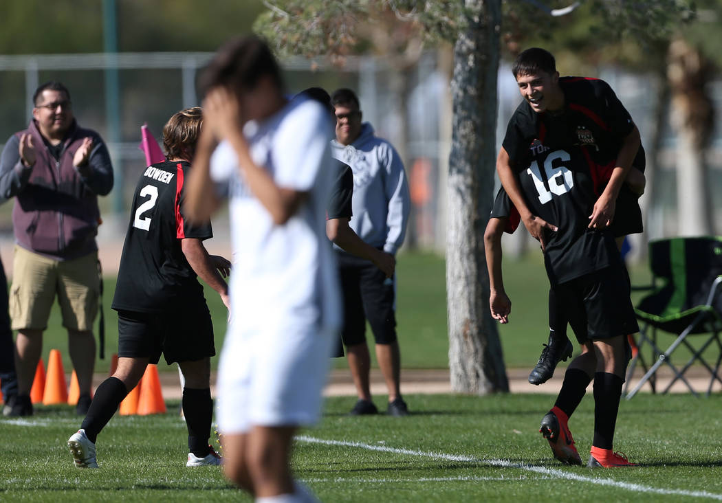 Las Vegas’ Sergio Aguayo (18) is lifted up by Nathan Zamora (16) in celebration after ...