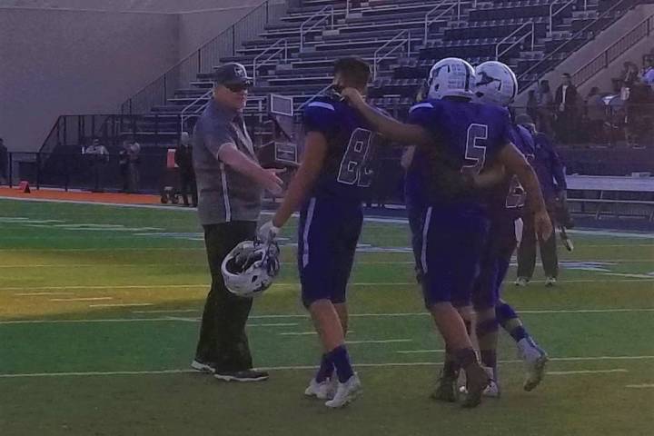 Needles seniors John Perez (80), Doogie Harvey (5) and Marcus Turner accept the Class 2A sta ...