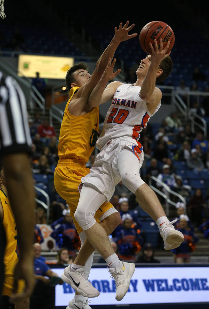 Bishop Gorman’s Noah Taitz shoots over a Bishop Manogue defender in the 4A NIAA state ...