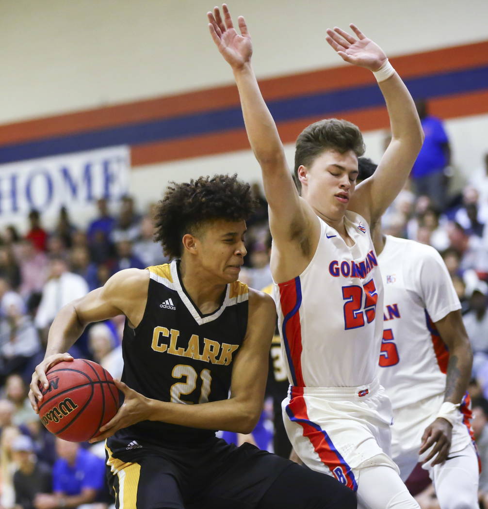 Clark’s Jalen Hill (21) drives against Bishop Gorman’s Chance Michels (25) durin ...