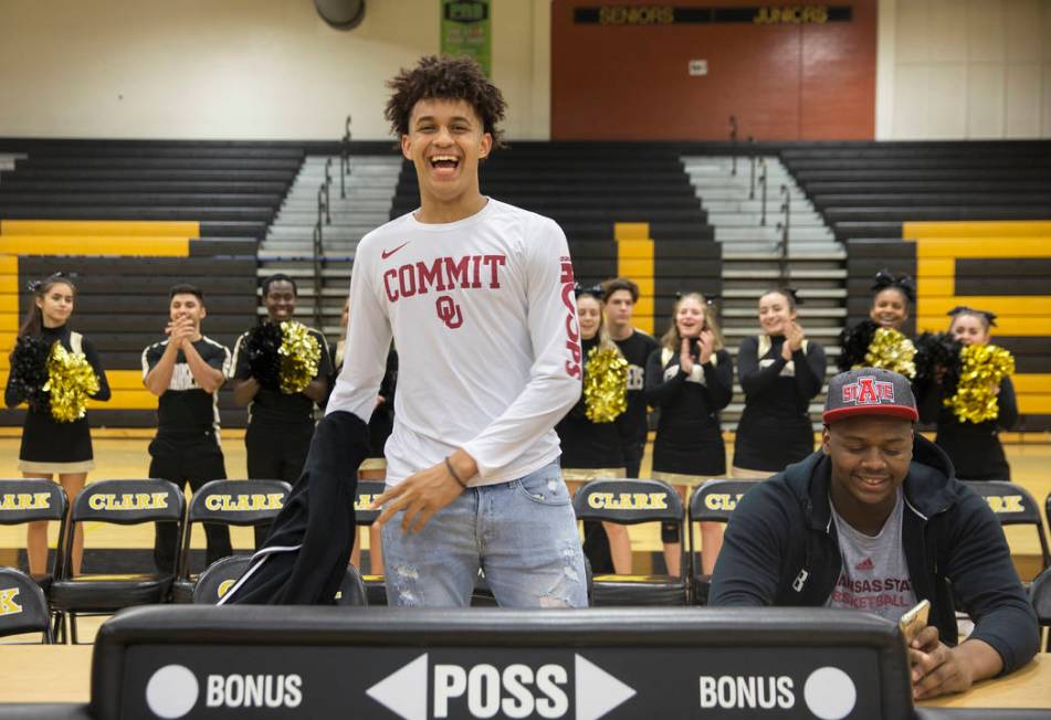 Clark senior Jalen Hill, left, shows off his Sooner colors during an event to announce his c ...