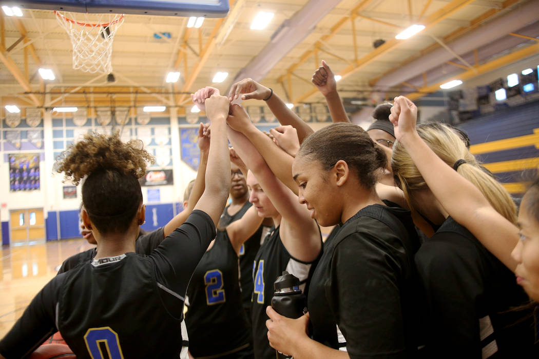 Sierra Vista High School’s girls basketball varsity team cheers together in a huddle d ...