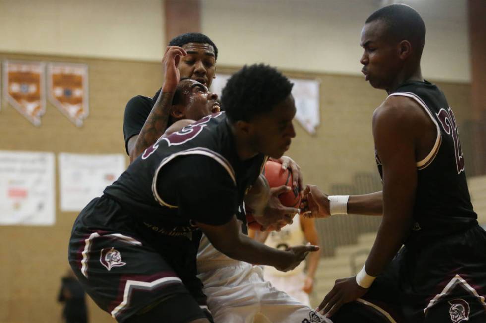 Democracy Prep’s Daniel Plumer (4) is triple-teamed against Cimarron-Memorial in their ...