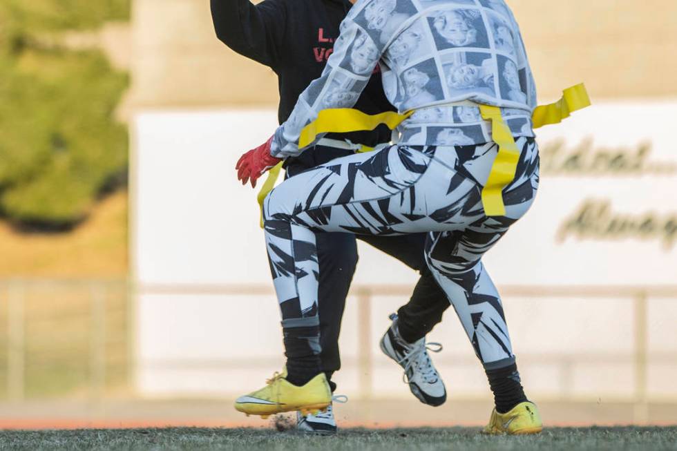 Las Vegas quarterback Sabrina Saldate dishes the ball before being tackled during flag footb ...