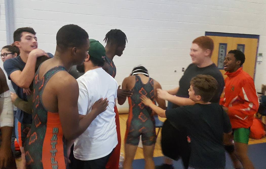 Mojave wrestlers celebrate their team victory after Jayzen Cabbab (center) recorded a pin at ...