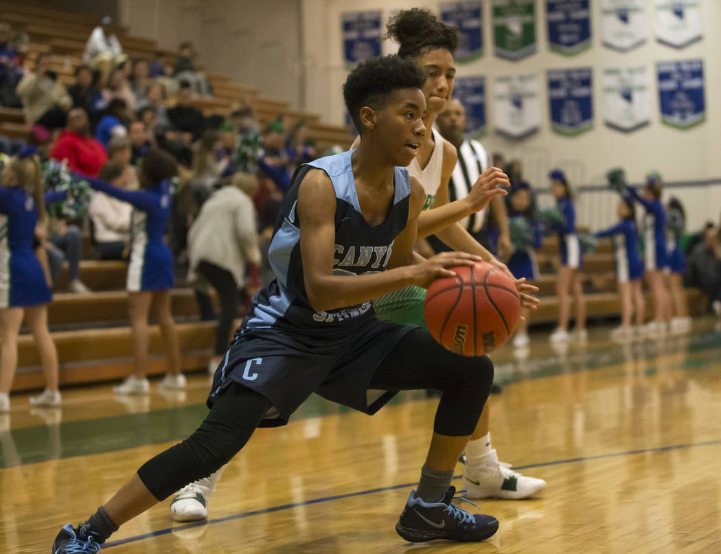 Canyon Springs guard Kayla Johnson (23) drives the ball past Green Valley’s Rian Ander ...