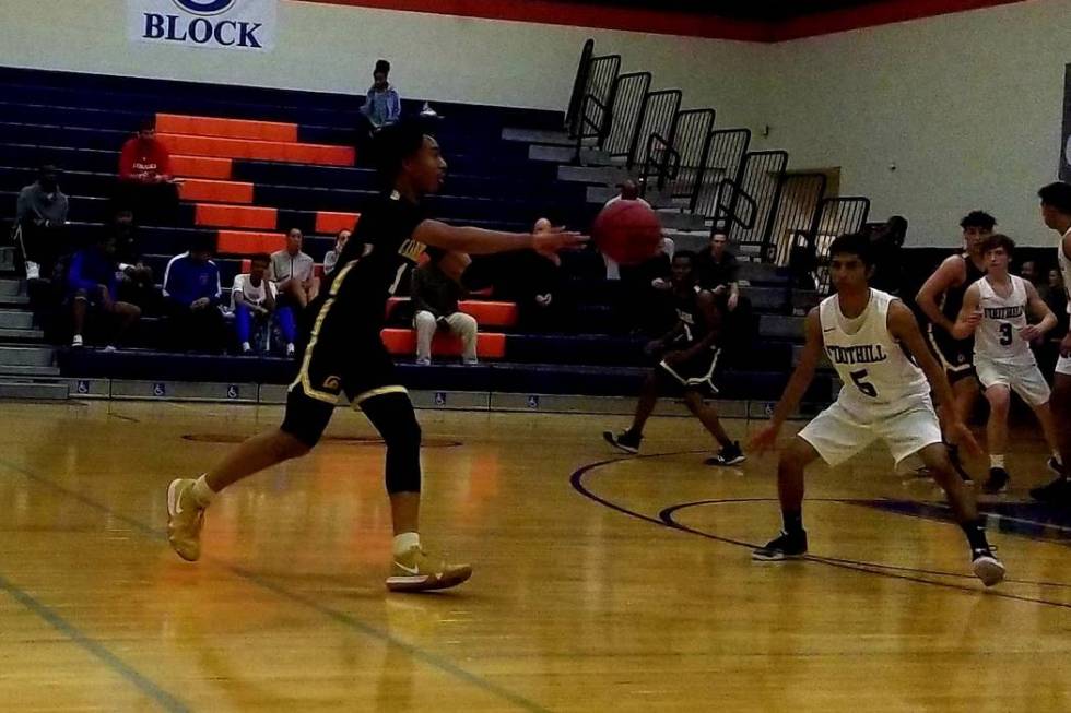 Clark’s Frankie Collins, left, fires a pass against Foothill on Saturday, Dec. 15, 201 ...