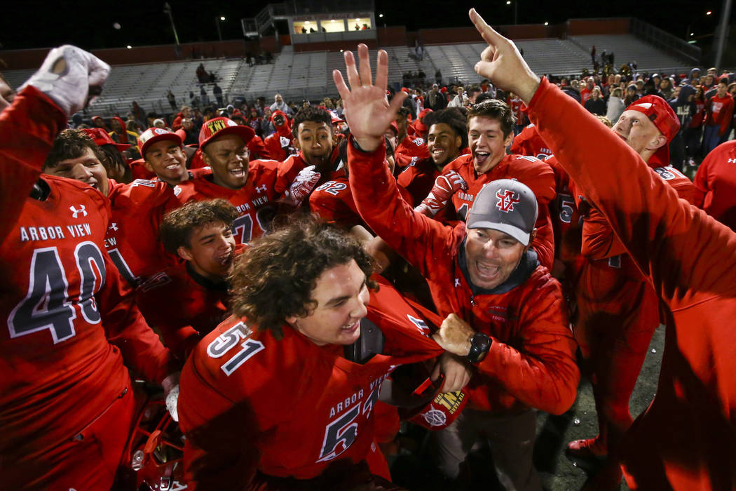 Arbor View head coach Dan Barnson, right, joins his players in celebrating their win over Fa ...