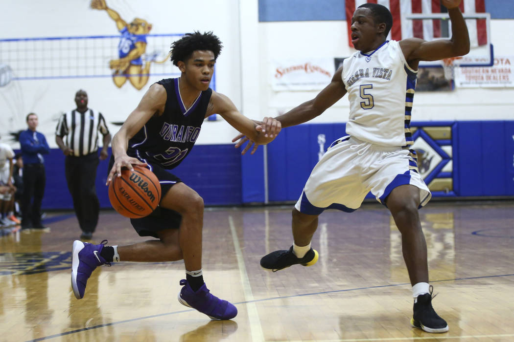 Durango’s Anthony Hunter (21) drives against Sierra Vista’s Isaiah Veal (5) duri ...