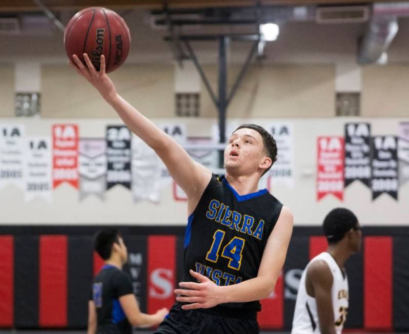 Sierra Vista junior Valton Mesic (14) slices to the rim past Bonanza senior Ian White (35) i ...