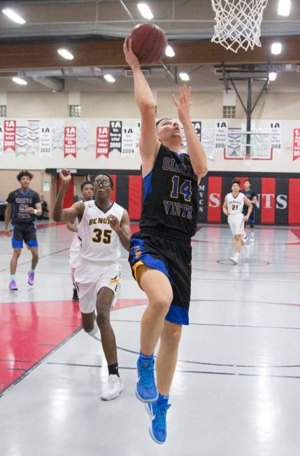 Sierra Vista junior Valton Mesic (14) converts a fast break layup past Bonanza senior Ian Wh ...