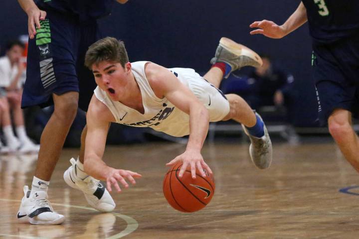 Foothill’s Fisher Welch (12) falls to the ground with the ball while under pressure fr ...