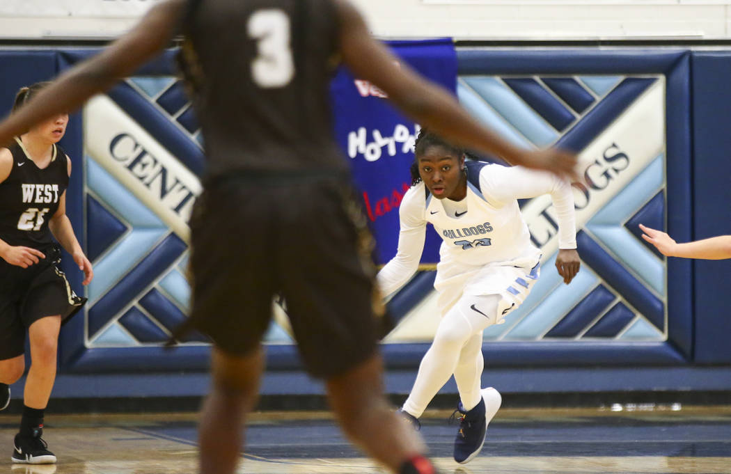 CentennialÕs Eboni Walker (22) brings the ball up court against West during a basketbal ...