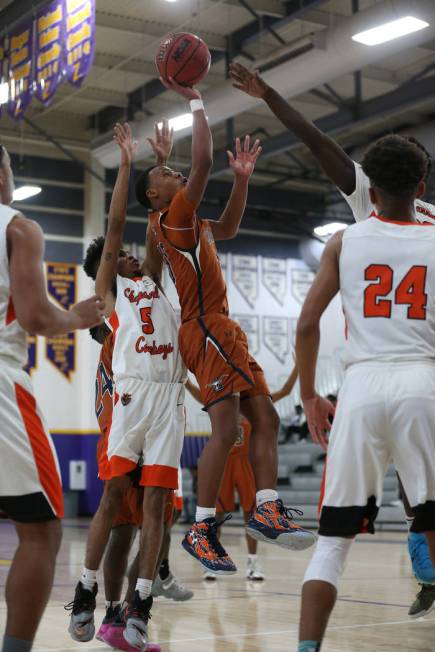 Legacy’s Emmanuel Austin (10) takes a shot under pressure from Chaparral’s Miles ...