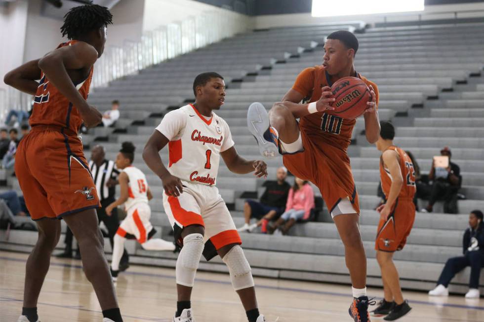 Chaparral’s Meshach Hawkins (1) looks on as Legacy’s Emmanuel Austin (10) grabs ...