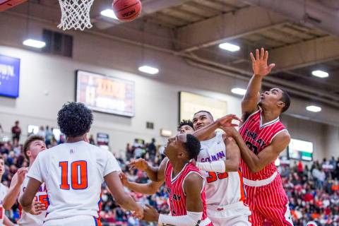 Findlay Prep’s Reggie Chaney (20), right, loses control of the ball as Bishop Gorman&# ...
