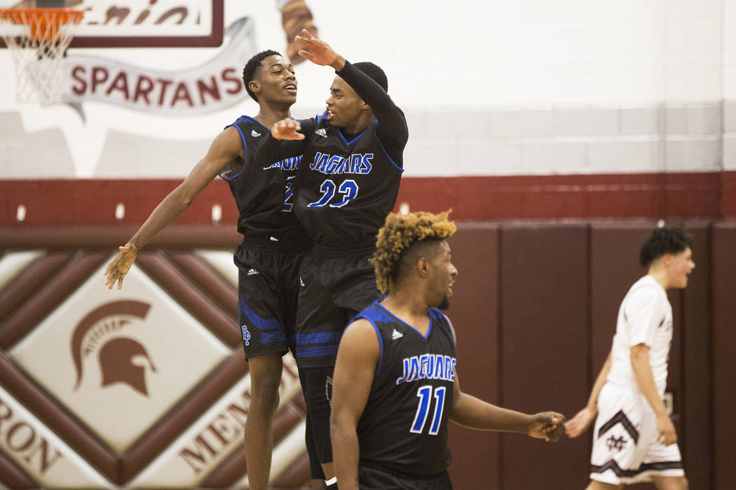 Desert Pines sophomore Dayshawn Wiley (2) celebrates with teammate Darnell Washington (13 af ...