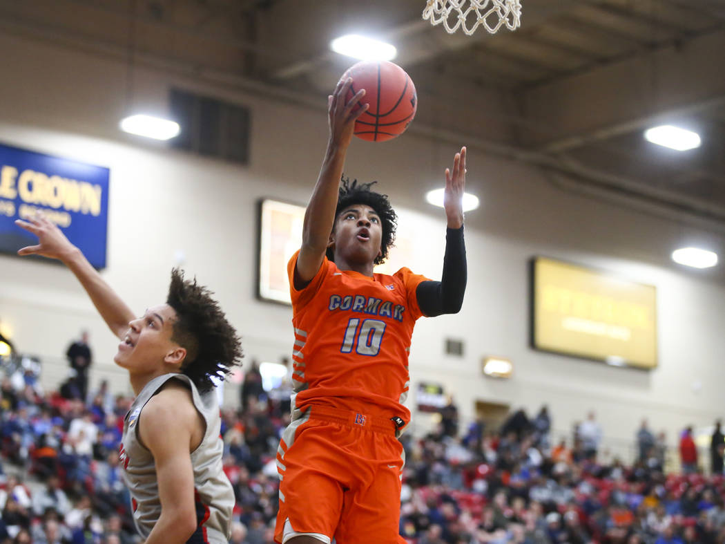 Bishop Gorman’s Zaon Collins (10) goes to the basket in front of Findlay Prep’s ...