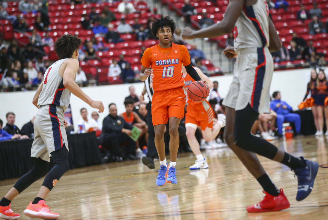Bishop Gorman’s Zaon Collins (10) brings the ball up court during the first half of th ...