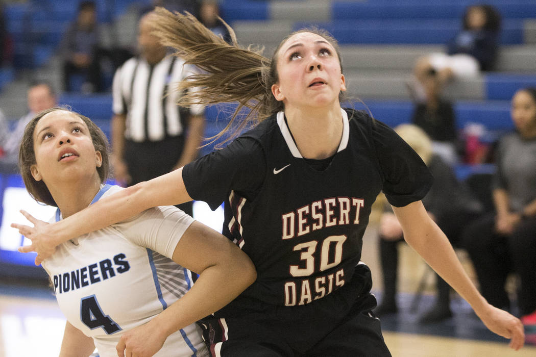 Desert Oasis senior forward Sierra Mich’l (30) boxes out Canyon Springs senior guard J ...