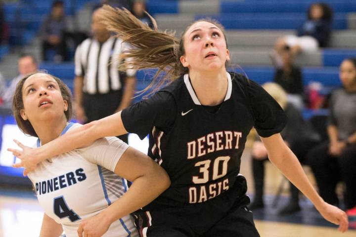 Desert Oasis senior forward Sierra Mich’l (30) boxes out Canyon Springs senior guard J ...