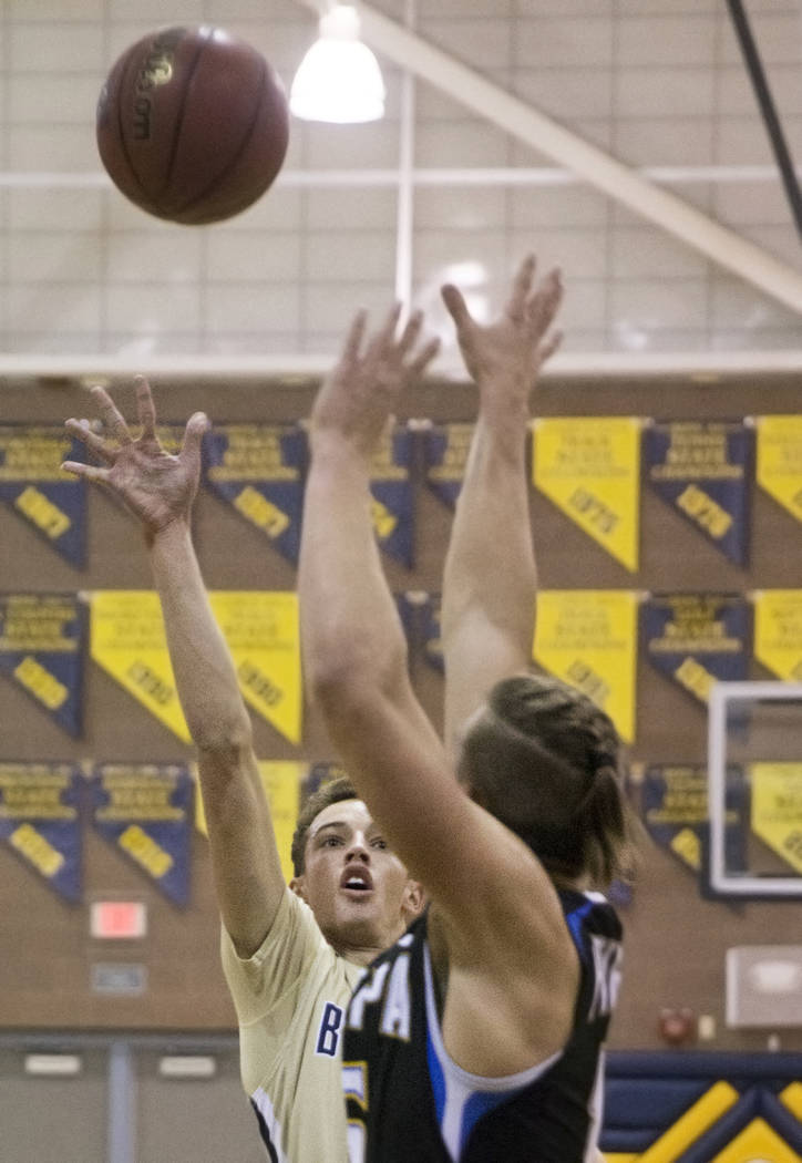 Boulder City senior guard Karson Bailey (14) shoots over Moapa Valley senior forward Jessup ...