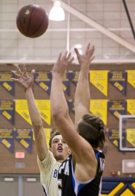 Boulder City senior guard Karson Bailey (14) shoots over Moapa Valley senior forward Jessup ...