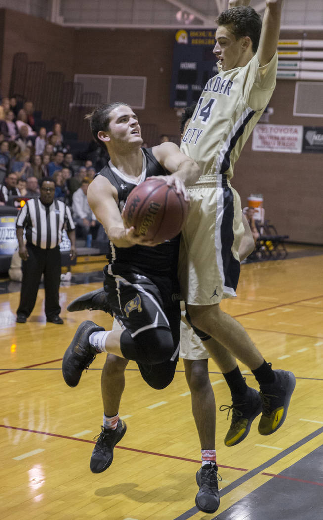 Moapa Valley senior guard Chase Hoy (2) drives baseline past Boulder City senior guard Kars ...