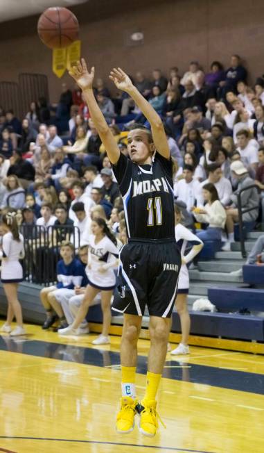 Moapa Valley sophomore guard Lucas Walker (11) shoots a corner three in the second quarter d ...