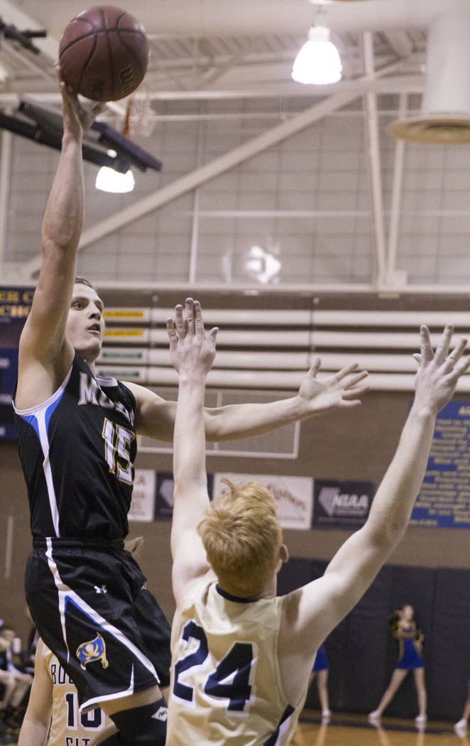 Moapa Valley senior forward Jessup Lake (15) shoots over Boulder City sophomore guard Matt M ...