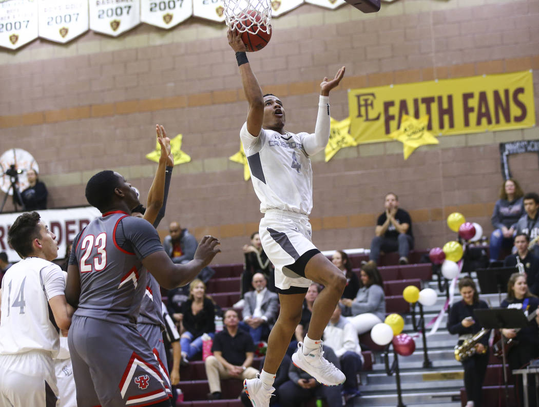 Faith Lutheran’s Sedrick Hammond (4) goes to the basket past Arbor View’s Jaylon ...