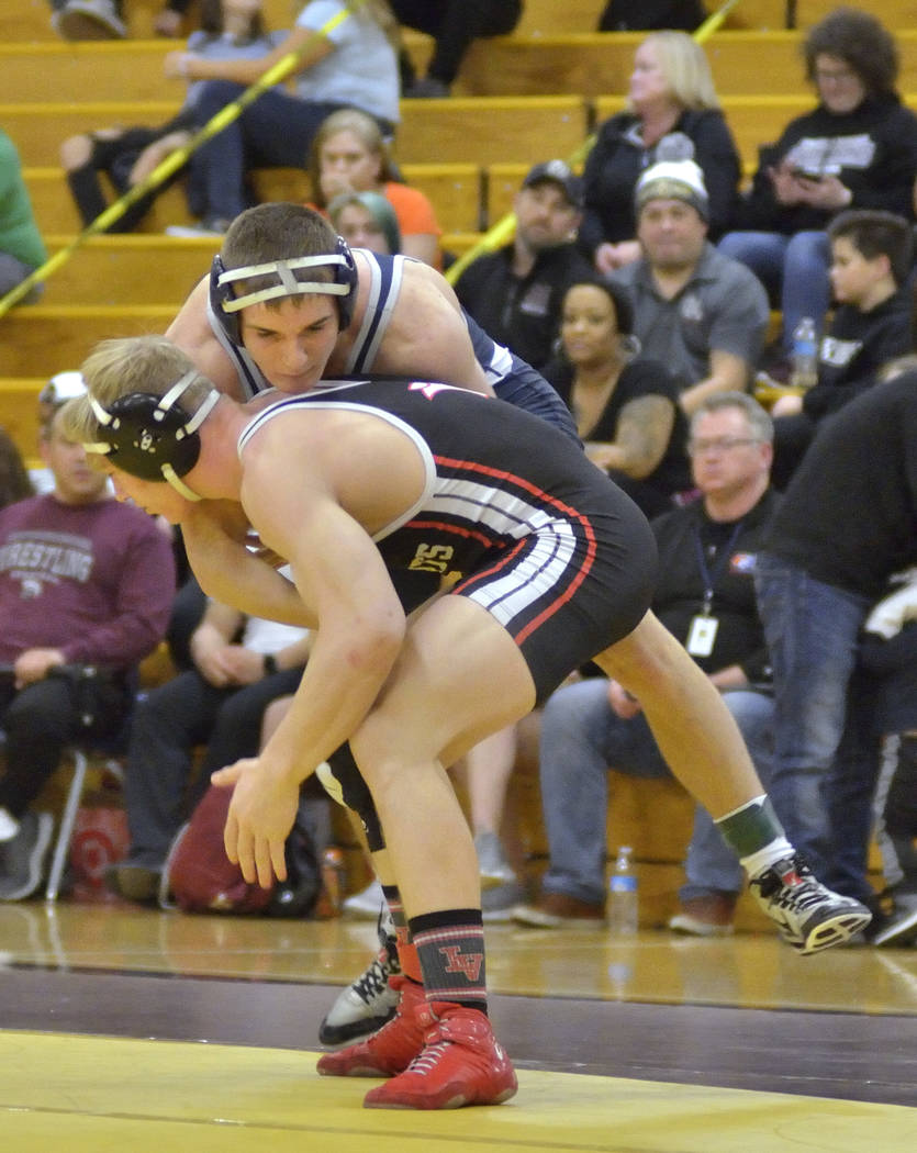 Caleb Roach of Cimarron-Memorial High School, bottom, and Kody Presser from Shadow Ridge Hig ...