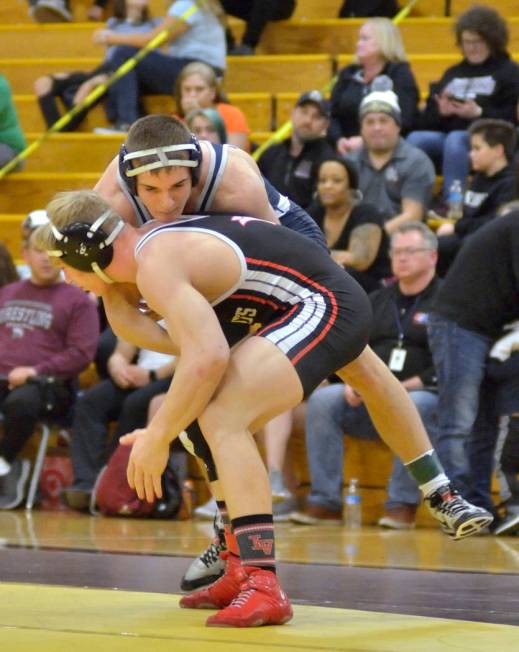 Caleb Roach of Cimarron-Memorial High School, bottom, and Kody Presser from Shadow Ridge Hig ...