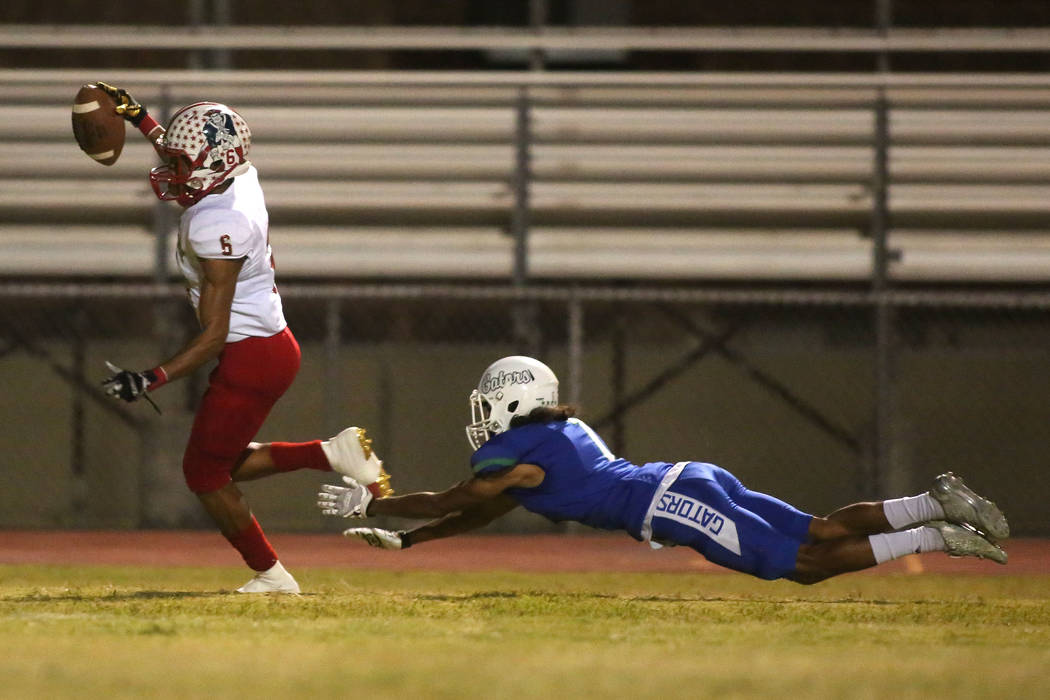Green Valley player Daunte Watson (1) dives in attempts to tackle Liberty Cervontes White (6 ...