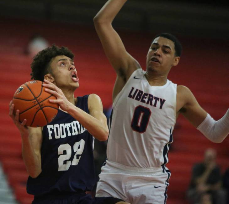 Foothill’s Jace Roquemore (22) drives to the net while under pressure from Liberty&#82 ...