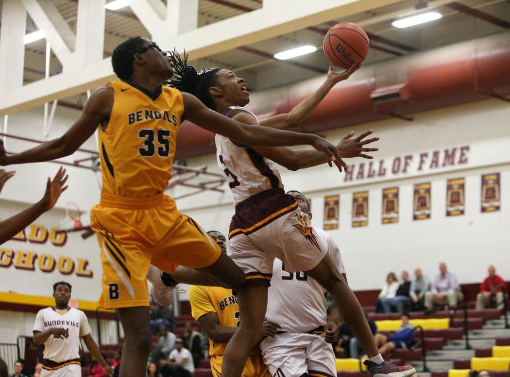 Eldorado’s Jonathan Thomas (3) jumps up to take a shot while being guarded by Bonanza& ...