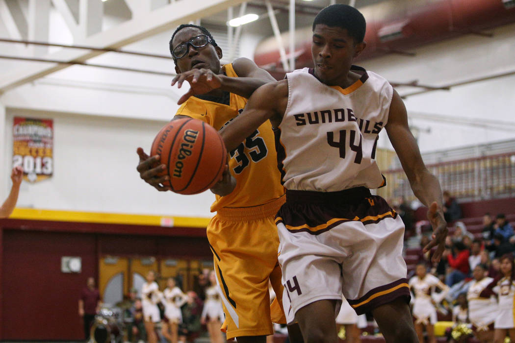 Bonanza’s Ian White (35) and Eldorado’s Johnny Perry (44) reach out for the ball ...