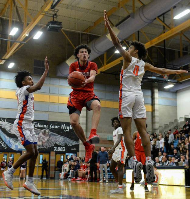 Coronado’s Richard Isaacs (2) jumps up to take a shot while being guarded by Bishop Go ...