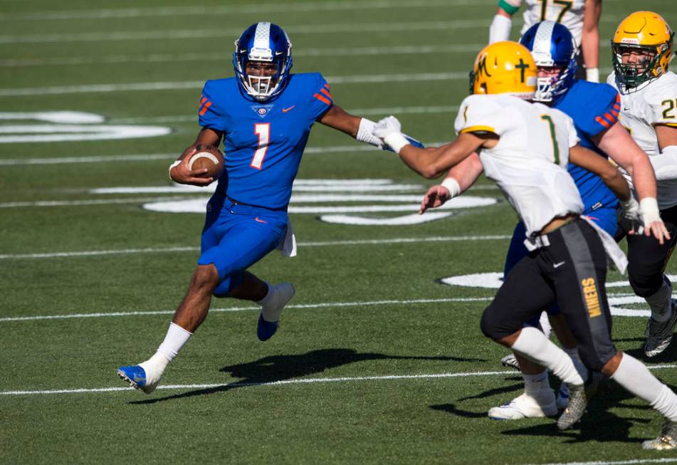 Bishop Gorman quarterback Micah Bowens (1) runs the ball against Bishop Manogue’s Elij ...