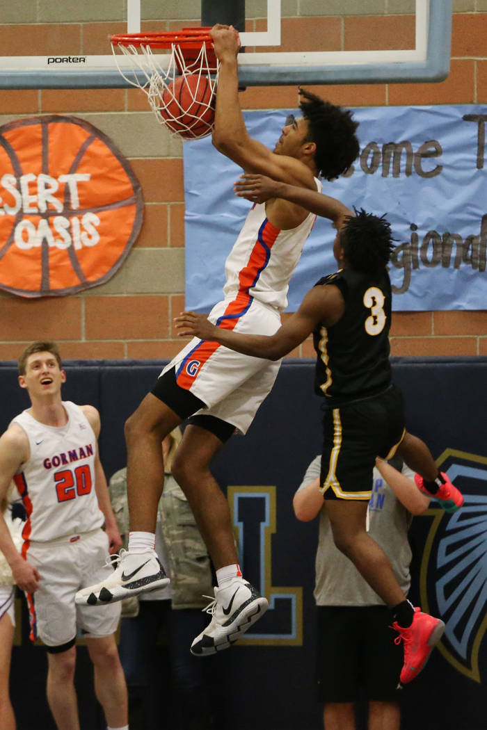 Bishop Gorman’s Isaiah Cottrell (0) goes up for a dunk under pressure from Clark&#8217 ...