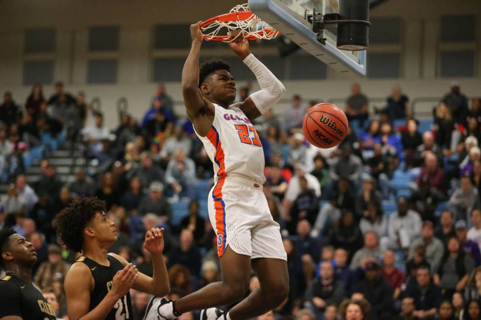 Bishop Gorman’s Mwani Wilkinson (23) dunks the ball against Clark in the Desert Region ...