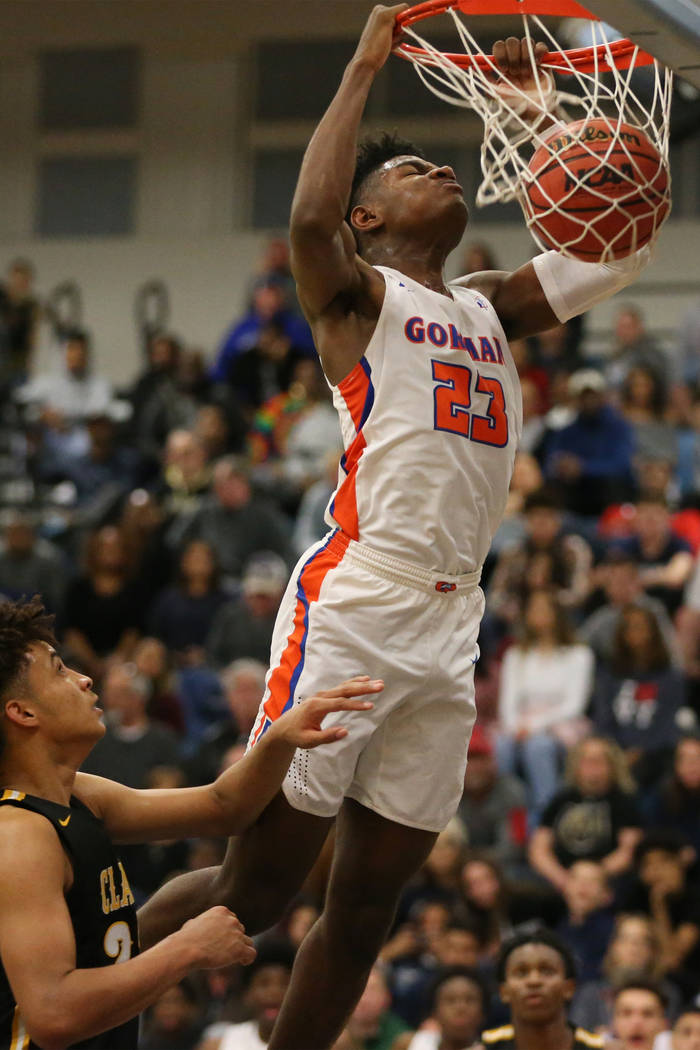 Bishop Gorman’s Mwani Wilkinson (23) dunks the ball against Clark in the Desert Region ...