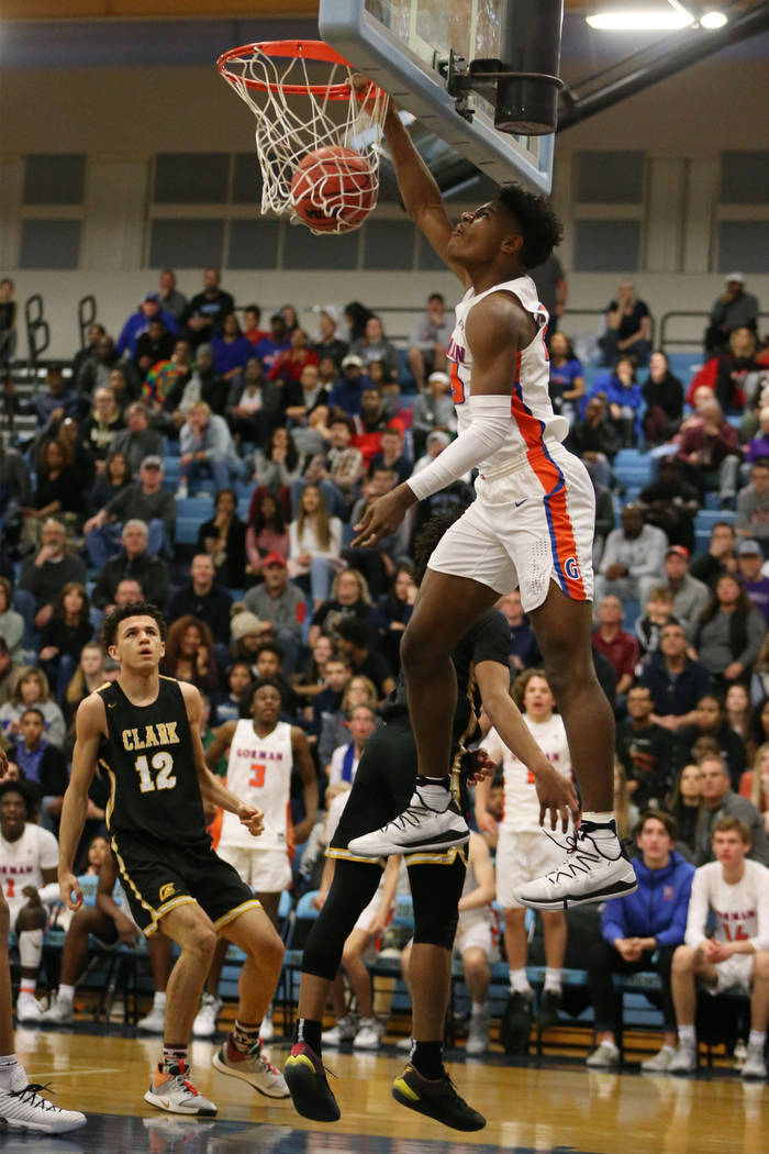 Bishop Gorman’s Mwani Wilkinson (23) dunks the ball against Clark in the Desert Region ...